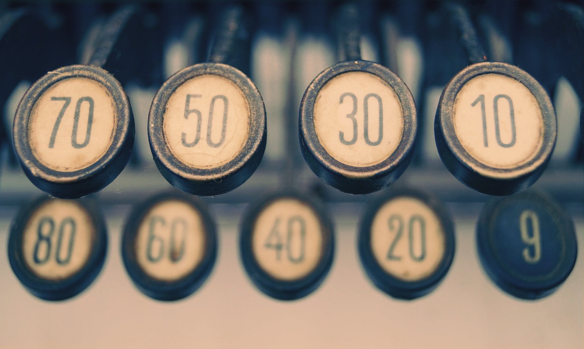 close up photography of gray adding machine